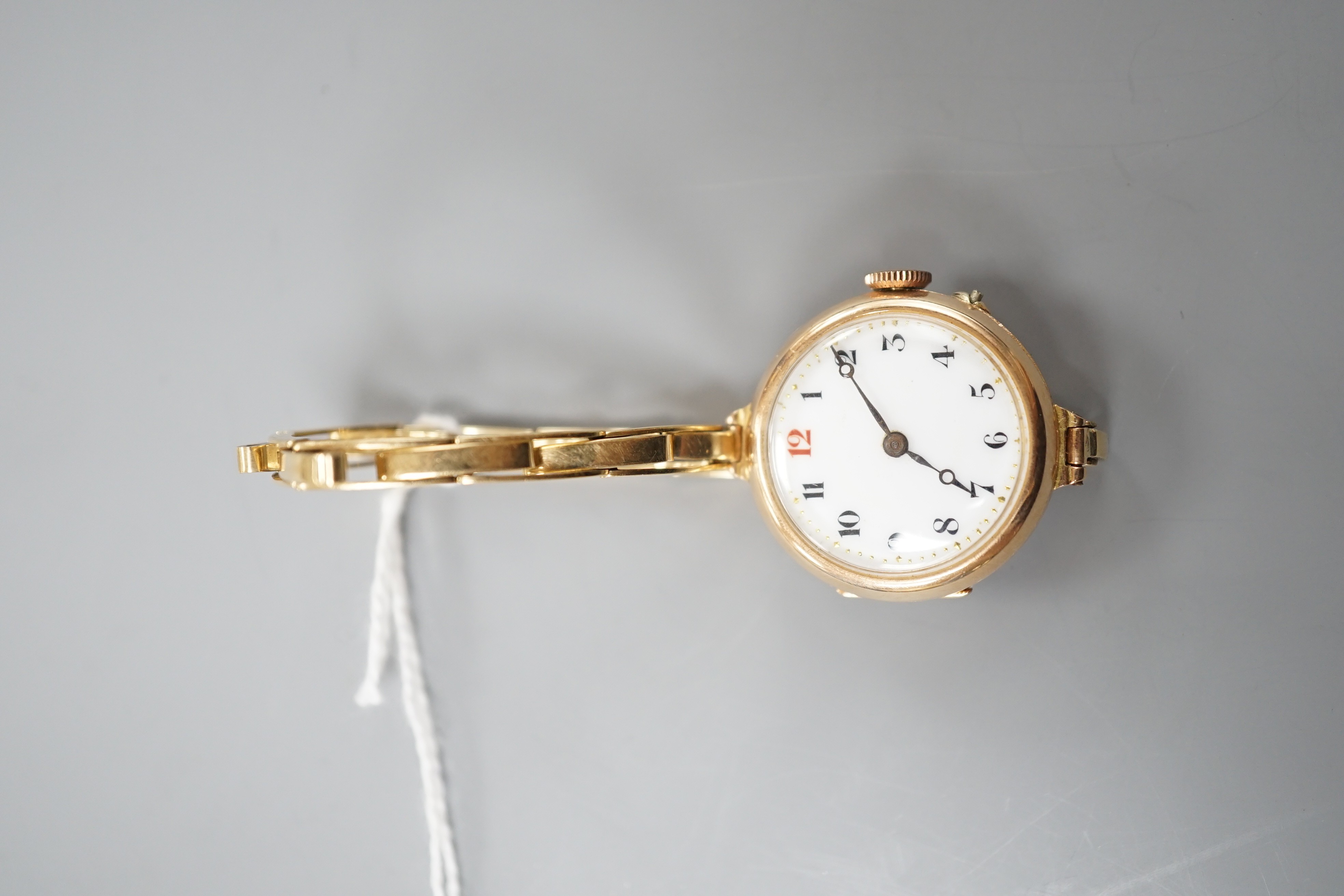 A lady's George V 15ct gold lady's manual wind wrist watch, London, 1918, on a 15ct flexible bracelet